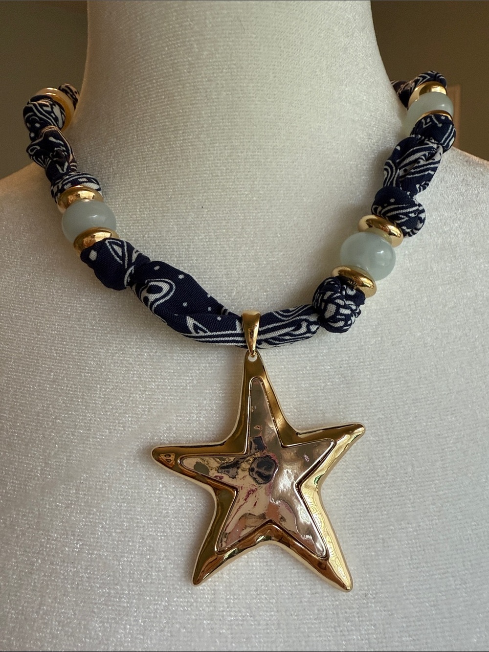 Two Tone Gold/Silver Star Pendant Necklace on Navy Fabric with Pale Green Beads